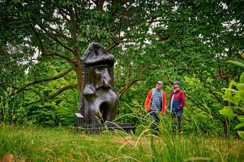 Two men looking at Henry Moore sculpture